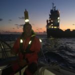 Moored cargo ship during night navigation-